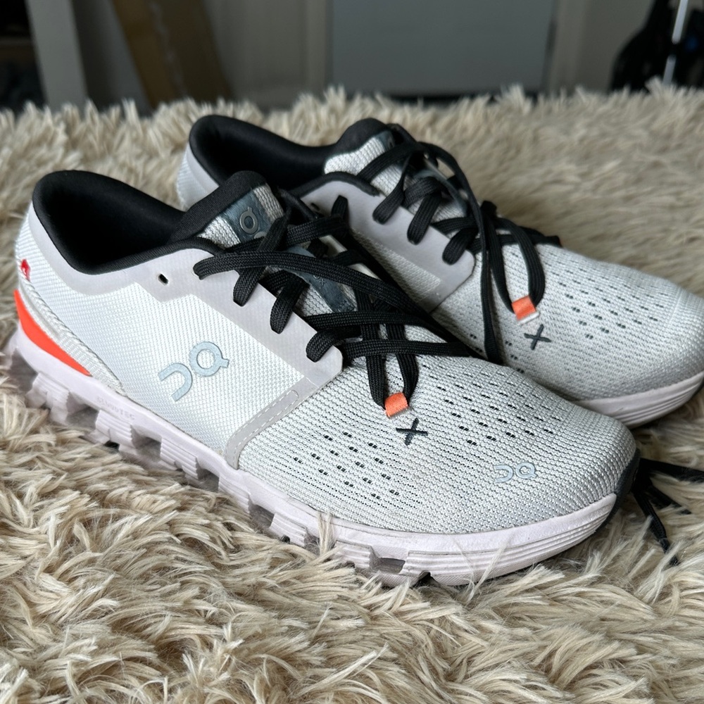 On Running White and Black Sneakers with Orange Accents